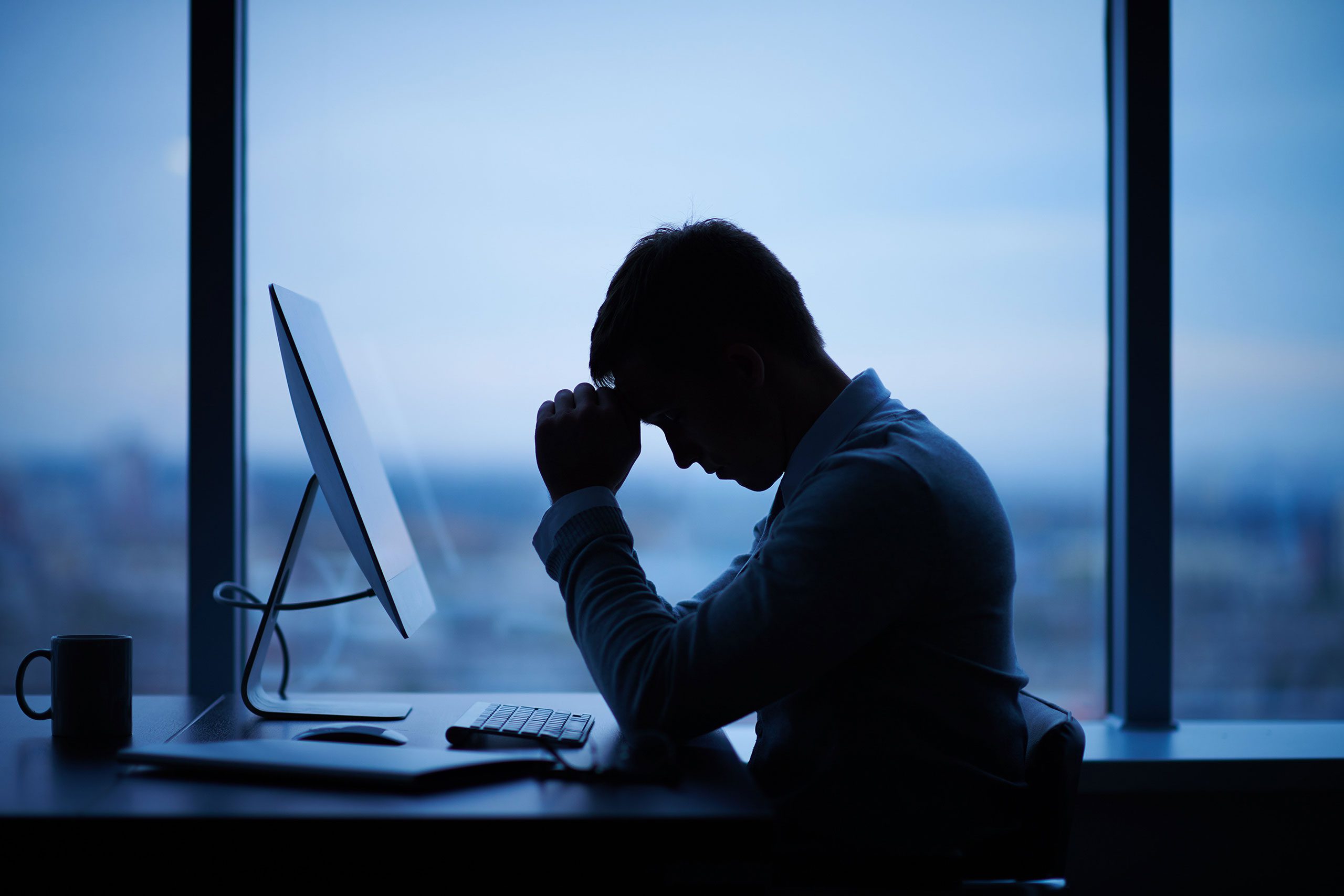 Stressed man at computer